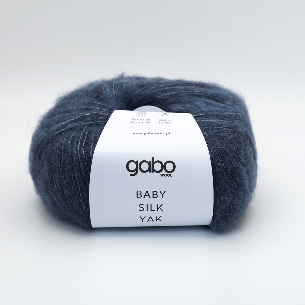 A skein of Gabo Wool Baby Silk Yak yarn in a dark navy blue color, featuring a white paper label with black text, set against a clean white background.