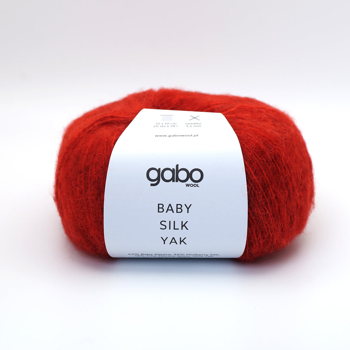 A skein of vibrant red mohair yarn with a white paper label reading 'gabo wool BABY SILK YAK' on a clean white background.